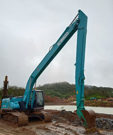 Image of excavator dredging sand on wet land