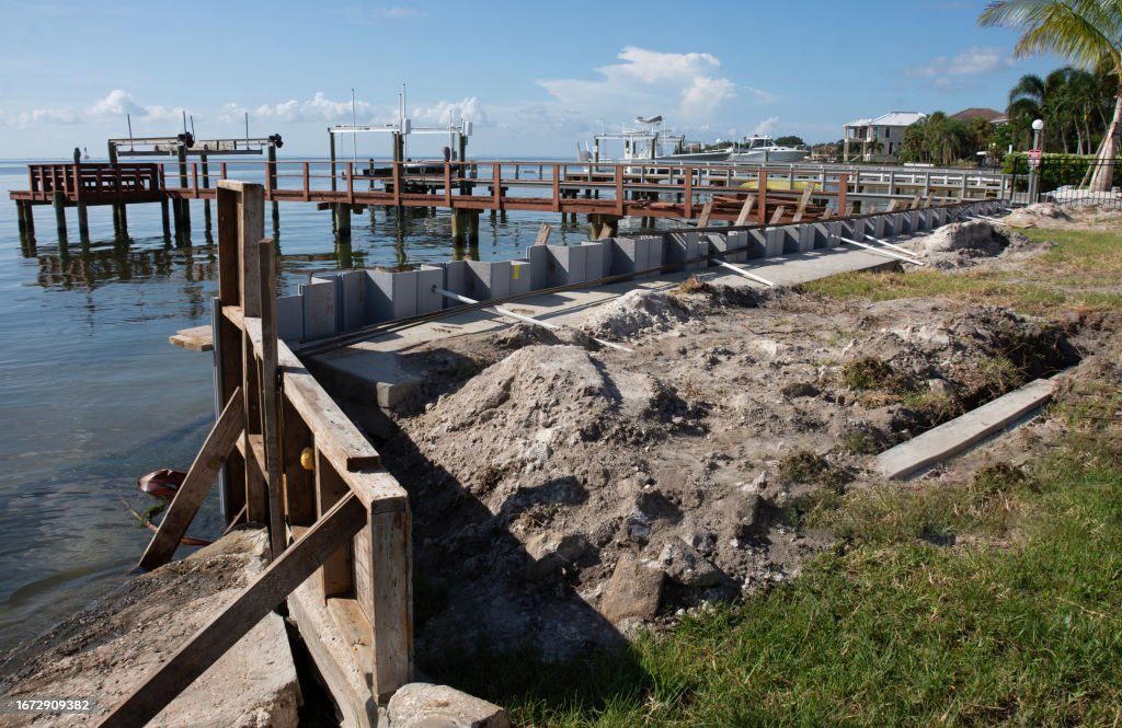 Image of seawall construction site with docks in the background